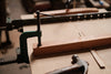 Woodworking clamps securing wood on a workbench